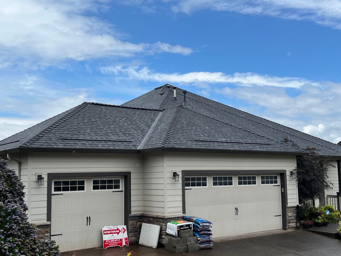 Hip roof with new shingles over a three-car garage