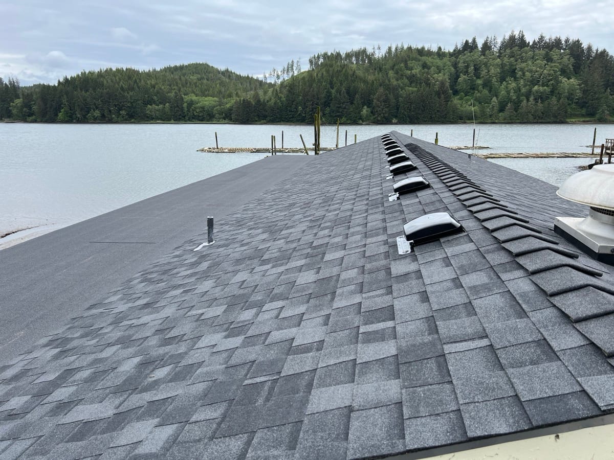 New shingles and ridge vents along the peak of a roof