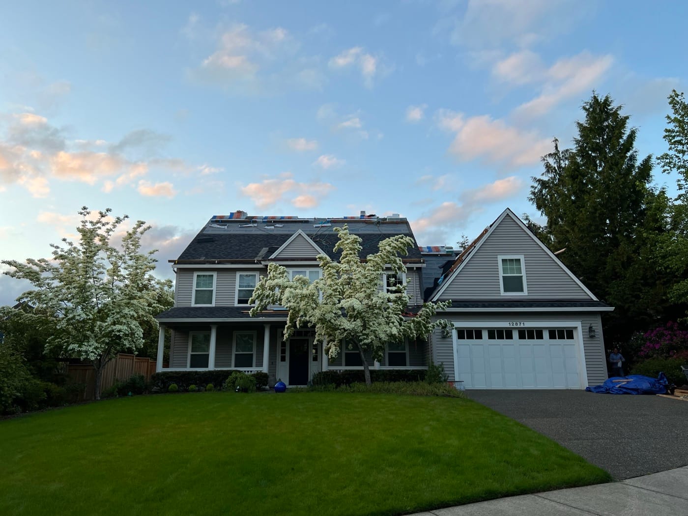 Gray home with a new roof photographed at dusk