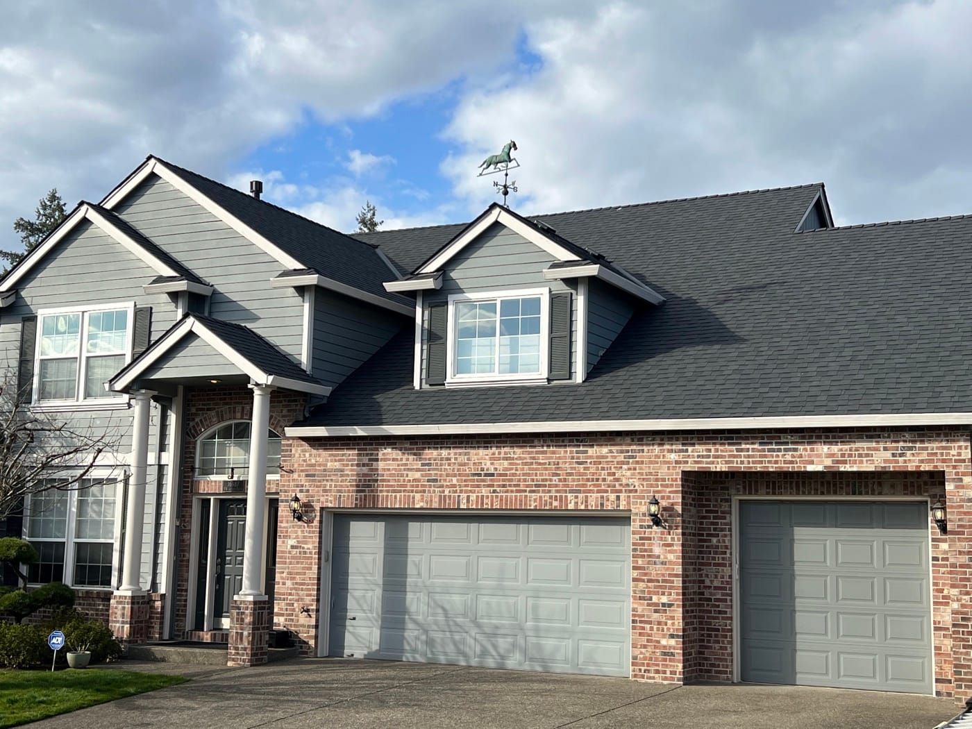 Home with a weathervane on a new architectural shingle roof